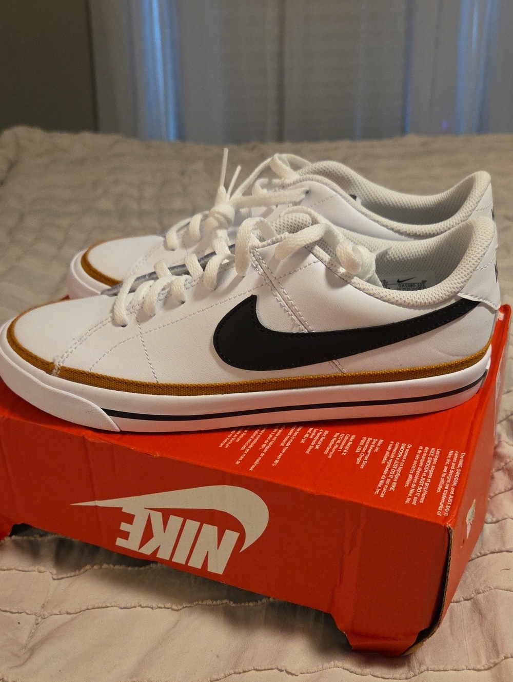Nike White Sneakers with Black Swoosh and Gold Accent. 6.5Y